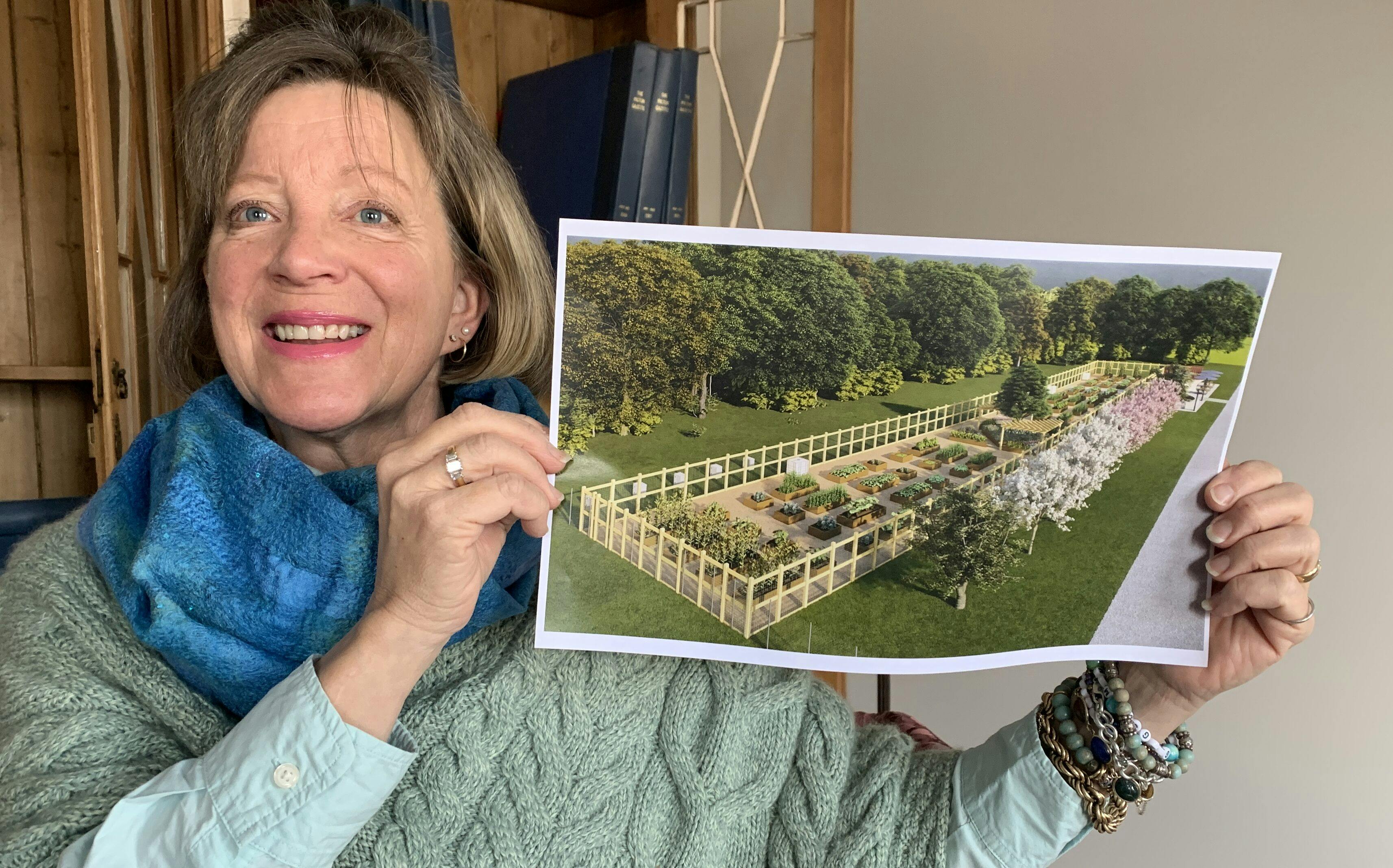 <p>Picton Community Gardens Chair Barb Mason shows off a rendition of what the communal grow space at Delhi Park might look like in three years time. (Jason Parks/Gazette Staff)</p>
